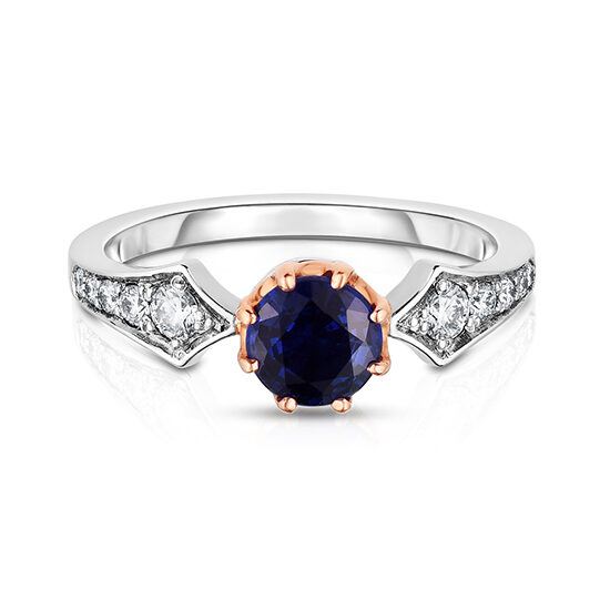 Platinum and 18k Rose Gold Vintage Ring with diamonds set band and a round blue sapphire